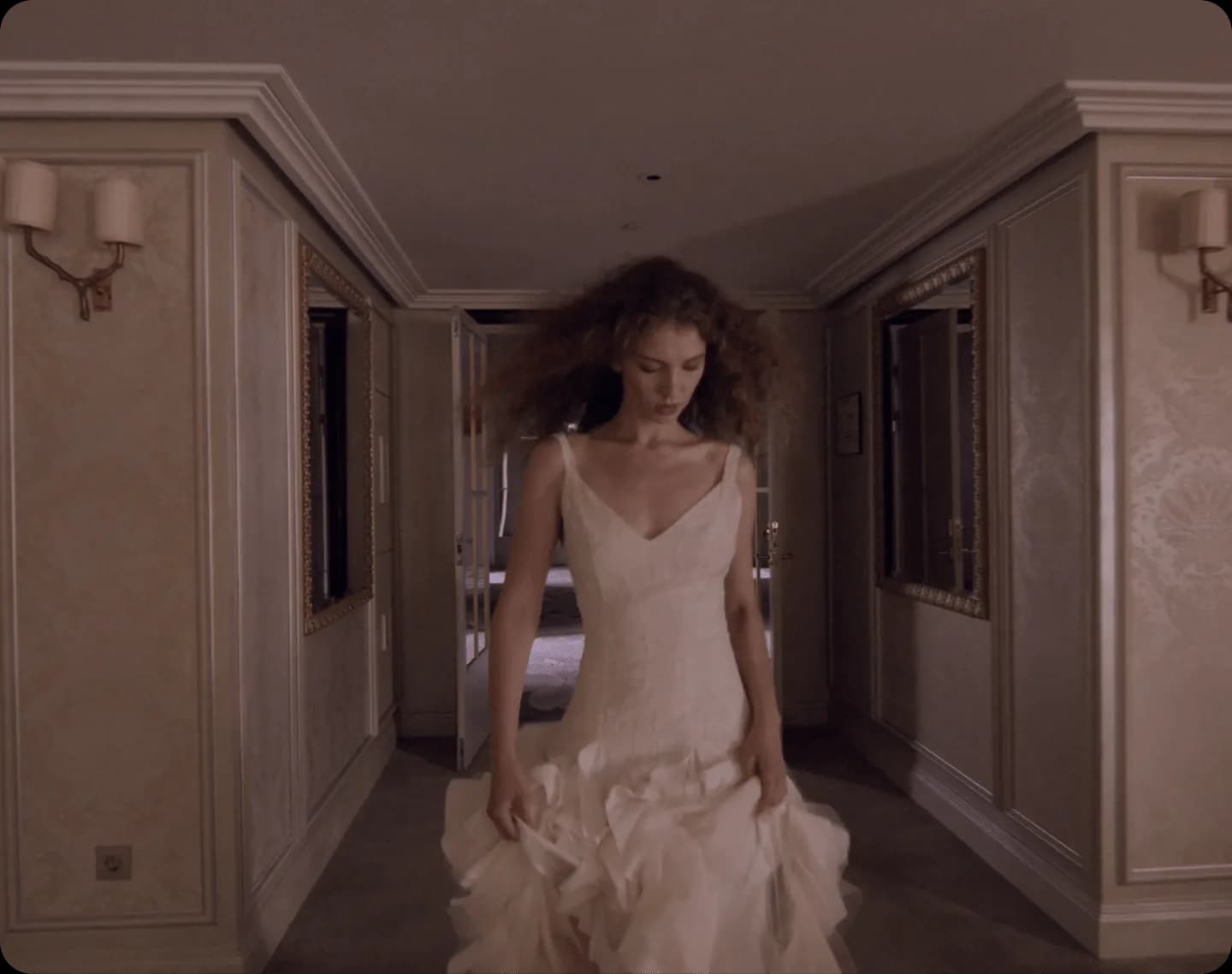 Woman in a white dress in a corridor editorial scene